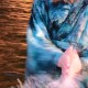 A still image of the motion of a woman in blue robes stands in water reflecting orange, and clapping her hand with the water between them.